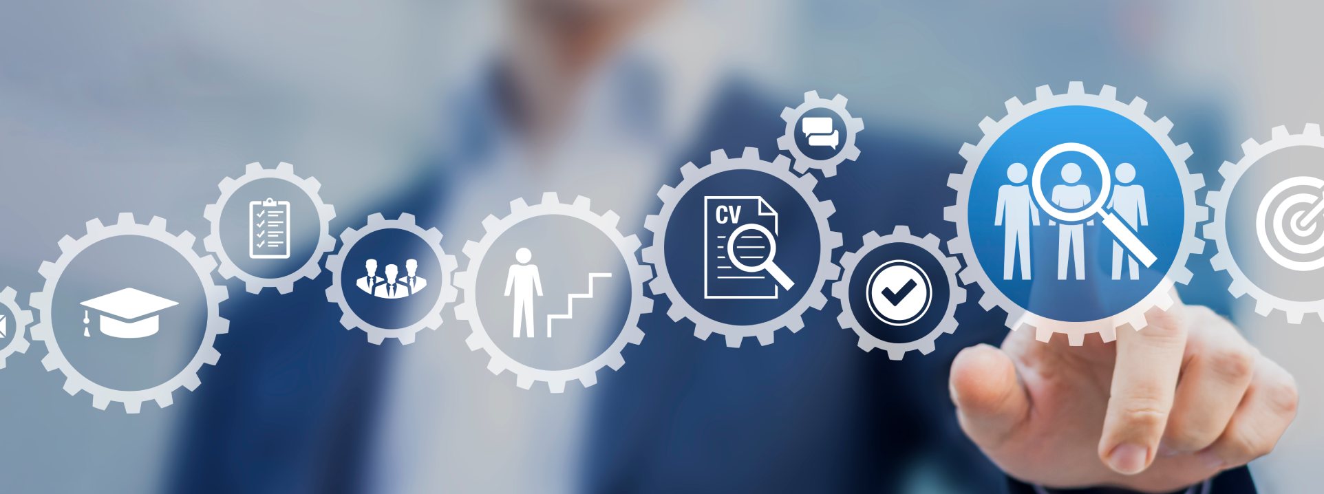 A hand touching an illuminated recruitment interface made of interlocking gears and icons.